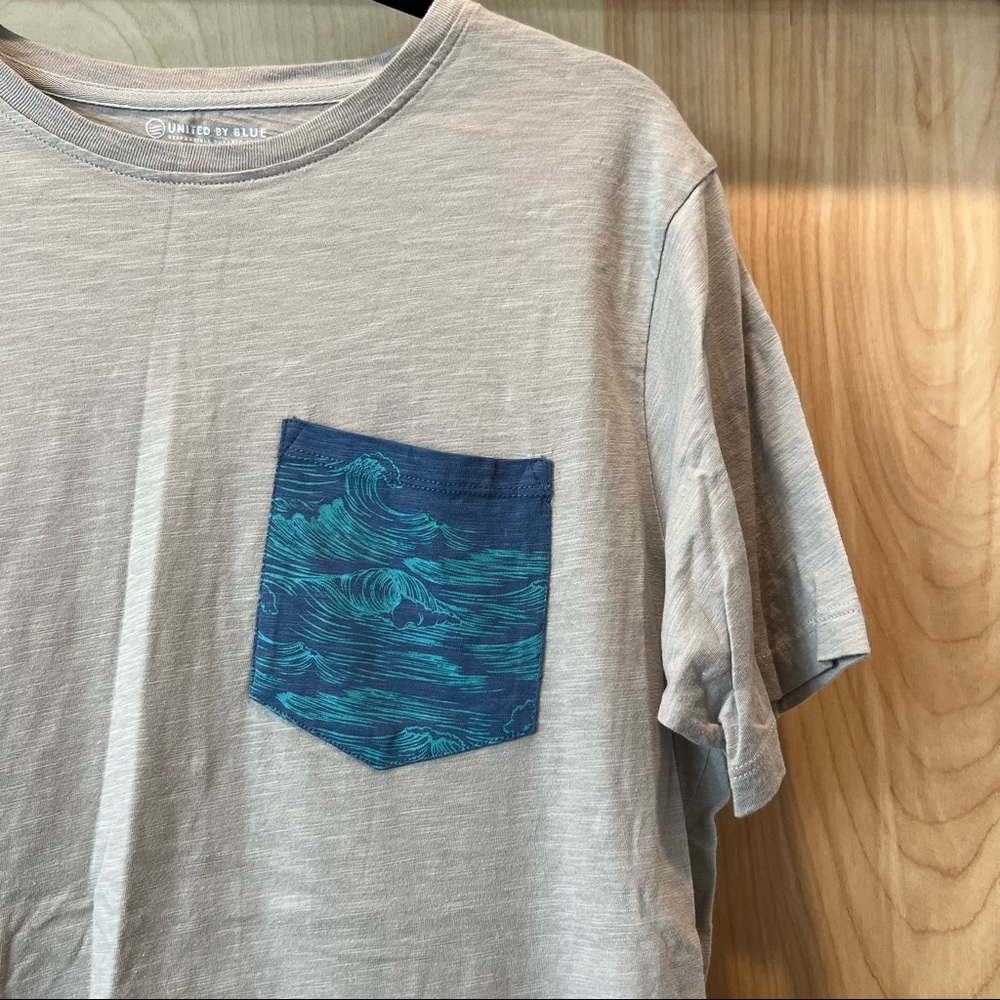 United by blue gray t-shirt with an accent pocket